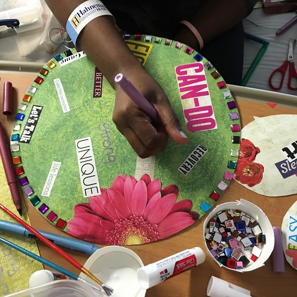 A person creating a collage during art therapy